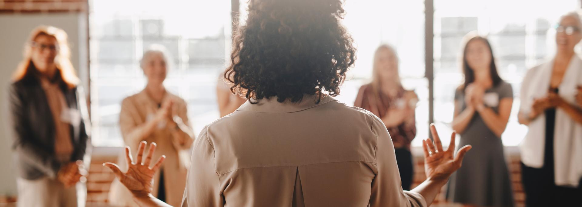 Woman speaking infront of audience 